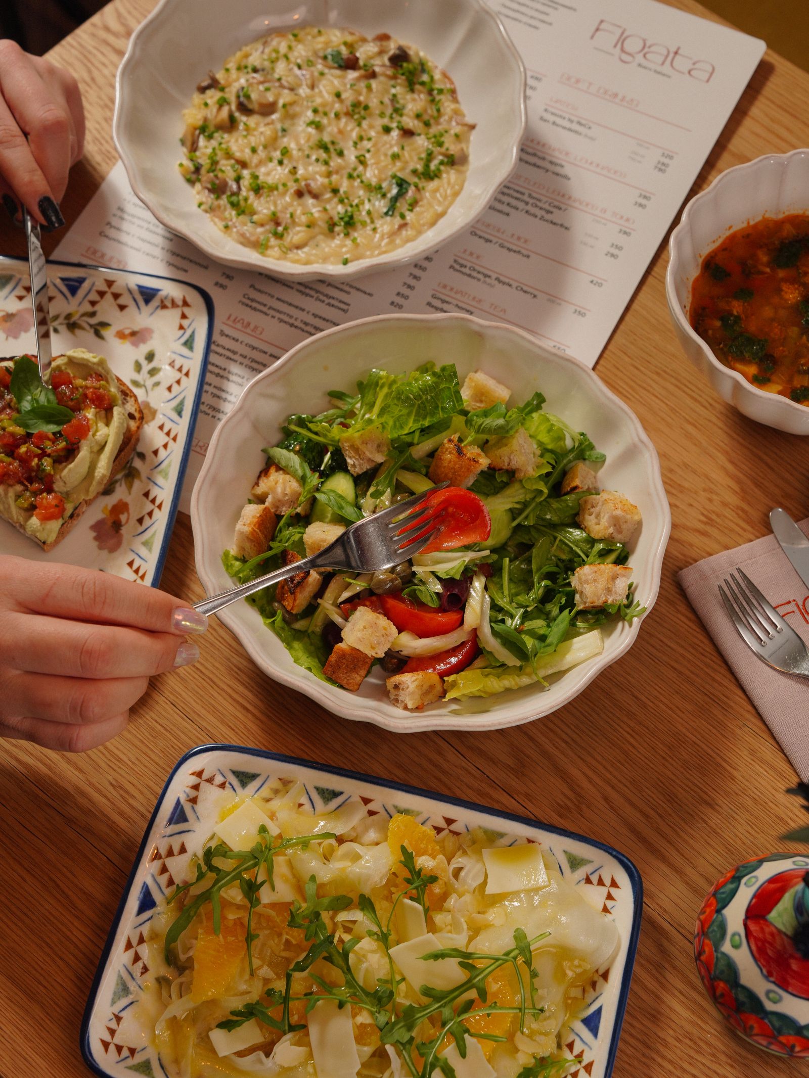 A table of colourful dishes ready for a restaurant meal