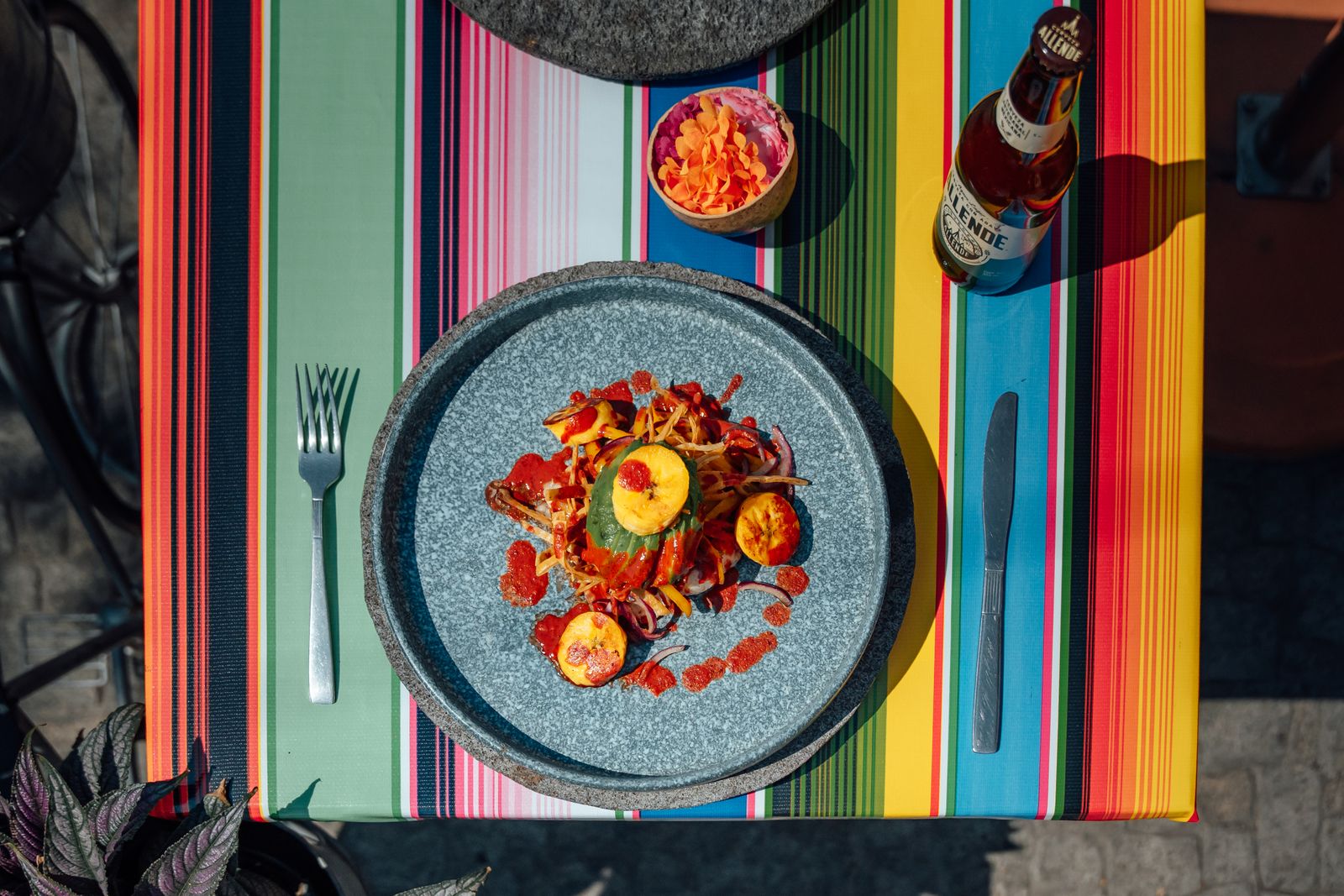 Outdoor dining table with a colourful plated meal